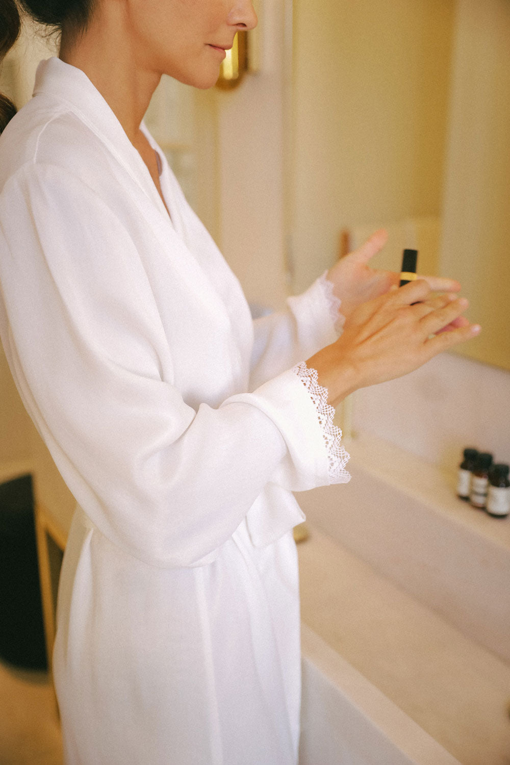 Detail from the wide sleeves with delicate hand-placed lace on the final of the sleeves, from a white silk robe from Leizi's Silky Dreams Collection
