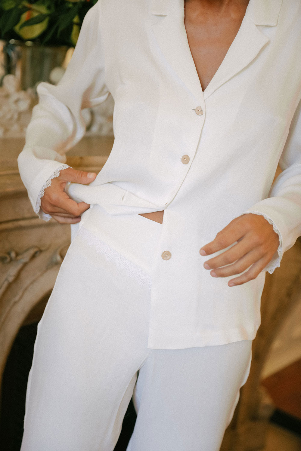detail of the pajama set in white silk made from orange peel.