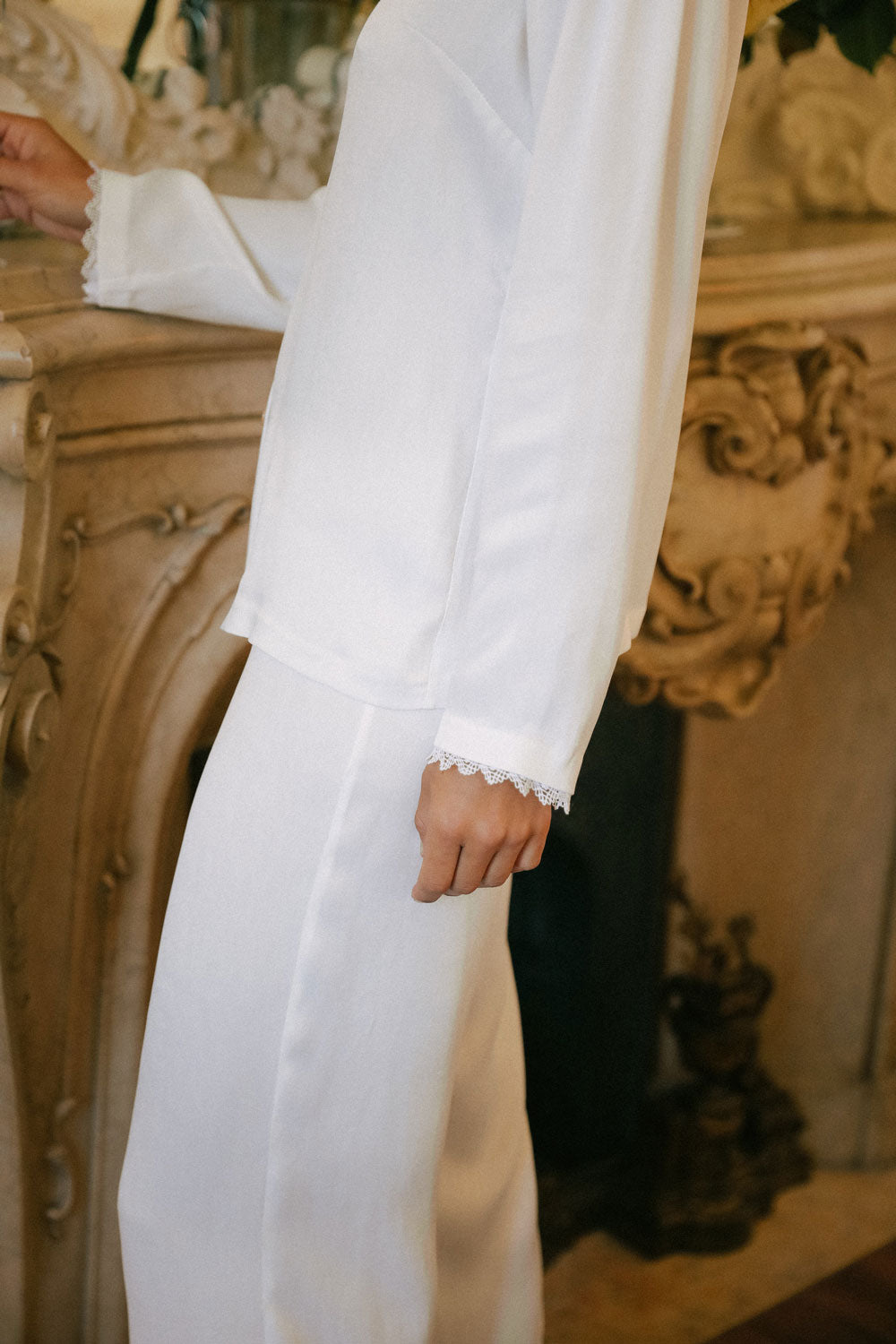 detail of the pajama set in white silk made from orange peel.